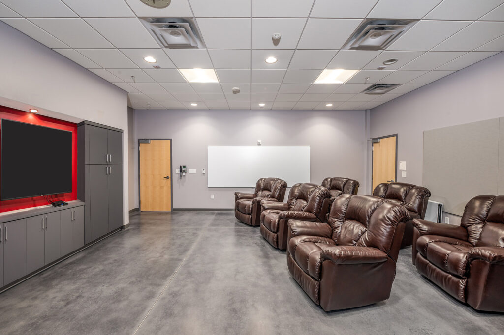 A breakroom with leather armchairs and TV at the Orlando Fire Station No. 9.